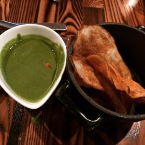 Potato chips with green sauce